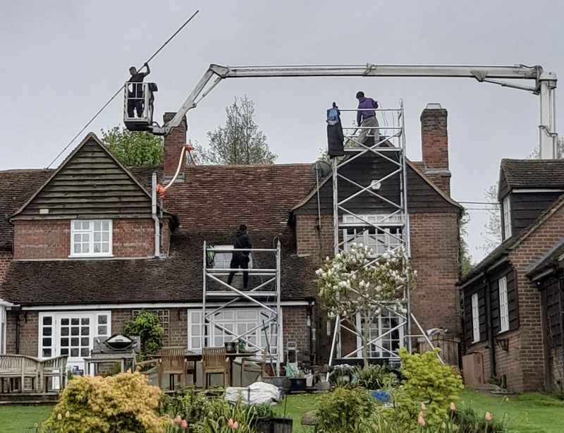 The Roof Moss Cleaners using cherry picker and scaffolding to clean roof safely and professionally in Chatteris, Cambridgeshire